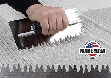 person spreading thinset with the sawtooth notched trowel for a large format tile installation