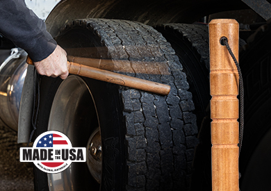 A man checking his big rig's tire pressure with the Tire Knocker