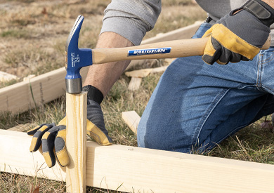 man hammering concrete forms with the Vaughan 999 Series Hickory Handled Hammer